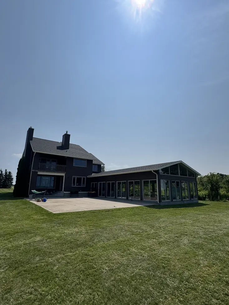 Finished roof replacement seen across the lawn of a large Western New York property — Alden, NY