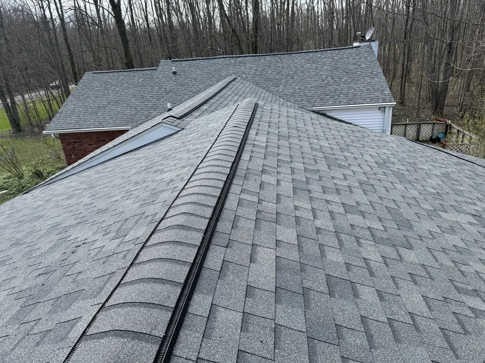 Hip and ridge lines on a completed gray architectural shingle roof