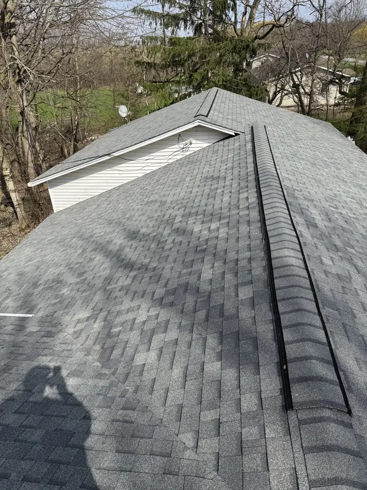 Completed gray architectural shingle roof over a home and attached garage in WNY