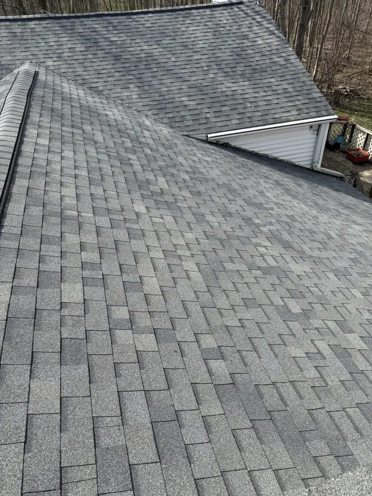 Gray architectural shingle roof slope and dormer on a Western New York home