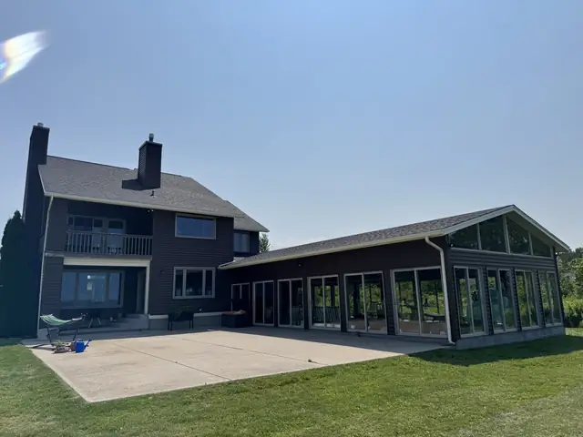 Completed roof over the rear elevation and attached sunroom of a Western New York home
