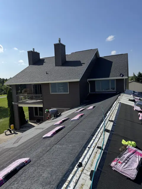 Owens Corning shingle bundles staged along fresh underlayment before installation on a WNY roof
