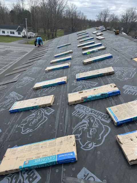 New plywood roof decking being installed during a Western New York roof replacement by TNE