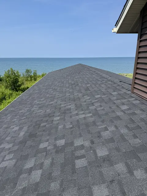 New architectural shingle roof on a lakefront Western New York home, ridge running toward the water