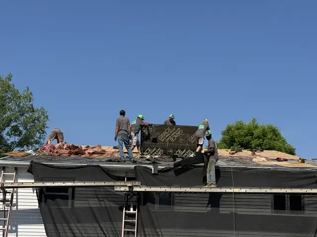 Old shingles being removed during a full roof replacement in Western New York