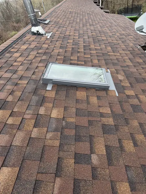 Skylight flashing set into fresh architectural shingles by TNE Roofing & Siding